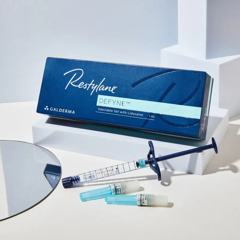 Restylane Defyne injectable gel packaging with syringe and vials on a white background. Hyaluronic acid dermal filler for facial contouring and deep lines or wrinkles.